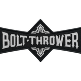 Black and white woven patch with the Bolt Thrower band logo, showing the name “BOLT·THROWER” in bold white lettering with ornamental motifs above and below the center.