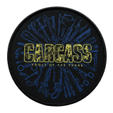 Carcass Tools of the Trade round woven patch with surgical tools design in blue and yellow on black background