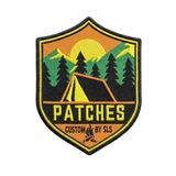 Custom camping patches with tent, pine trees and mountain sunset design on shield-shaped woven badge