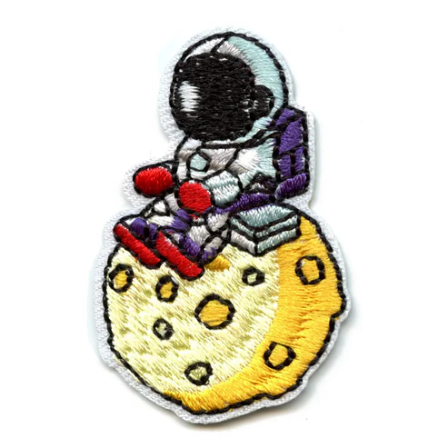 Small Astronaut Sitting On A Moon Patch